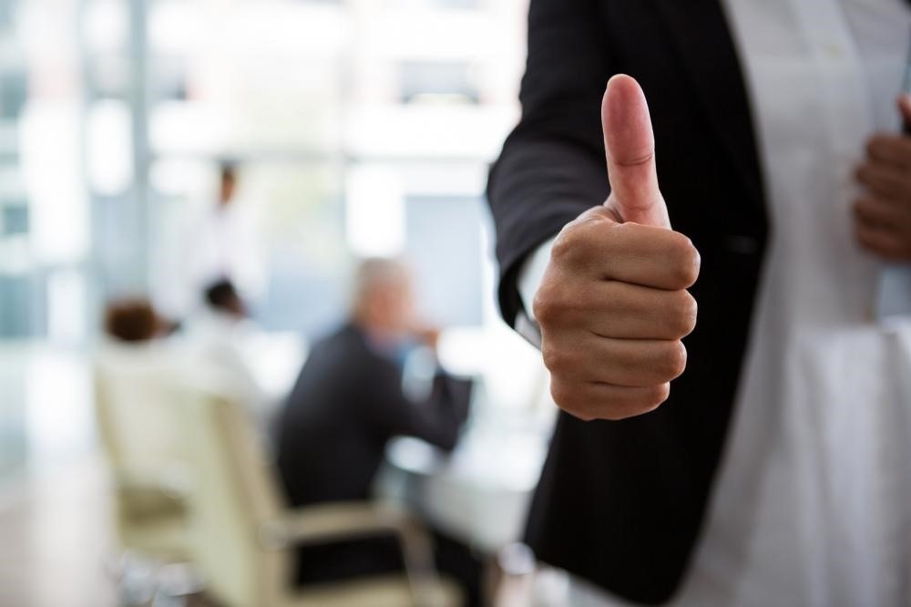 thumbs up gesture, representing an agreement being reached via mediation