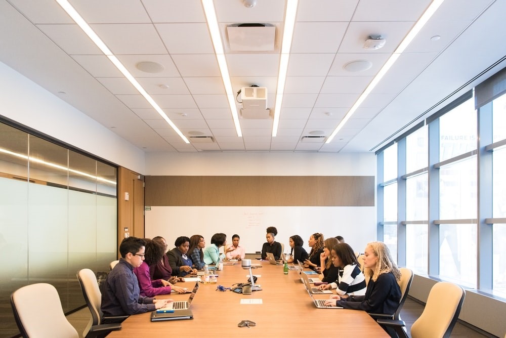 employees sitting inside a boardroom at the office